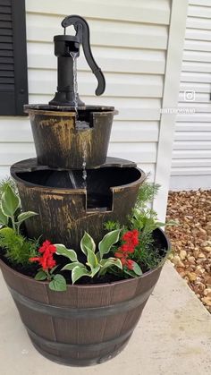 a water fountain with plants growing out of it