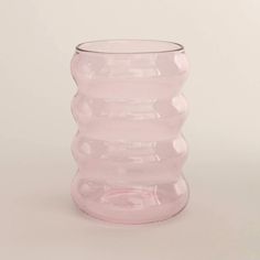 a pink vase sitting on top of a white table