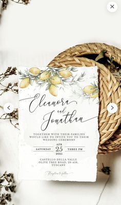 a wicker basket filled with lemons next to a wedding card