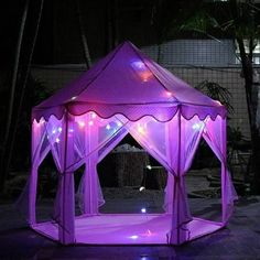 a purple tent with lights on it in the dark