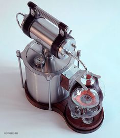 an old fashioned coffee grinder sitting on top of a table