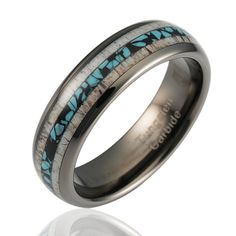 a wedding ring with turquoise and black inlays