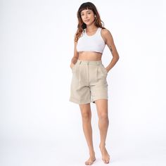 Vintage 00s shorts in beige with a high waist, front pleats and a cuffed hem. Three pocket design. Please see measurements and condition below. Every garment we sell is authentic vintage! You will receive the exact item photographed. Condition: Very good vintage. Best fits women's: 28 Tag: intenti Material:  76 Polyester 24 viscose MEASUREMENTS Taken from seam to seam while the garment is lying flat. Double the armpit, waist, and hips For reference, model is 5'9" and measures 35-27.5-39. Waist: 14" Hips: 21" Inseam: 7.5" Rise: 13" For sales and promotions, follow us @Shopexile Beige Trouser, 1950s Shorts, High Waisted Mom Shorts, Kawaii Sweater, White Babydoll Dress, Cream Mini Dress, Trouser Shorts, Shorts Y2k, Lace Party Dresses