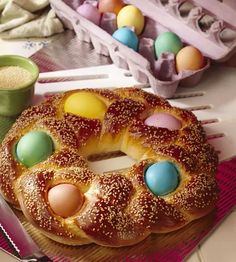 a bundt cake decorated with eggs and sprinkles sits on a plate