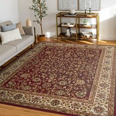 a living room filled with furniture and a rug on top of a hard wood floor