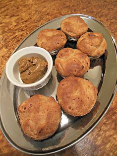 some muffins on a plate with dipping sauce