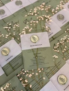 the wedding stationery is laid out on top of each other with flowers in them