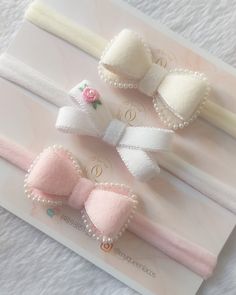 three little bows with pearls on them