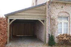 an old brick building with a wooden garage