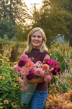 a woman is holding flowers in her hands