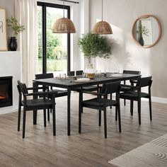 a dining room table with chairs and a fire place