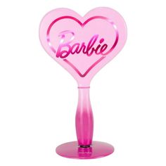 a pink heart shaped object with the word barbie on it