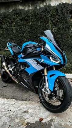 a blue and black motorcycle parked on the street