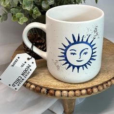 a coffee cup with a sun drawn on it and a price tag attached to the mug