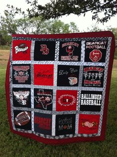 a quilt made to look like the college football team's name is displayed in front of a tree