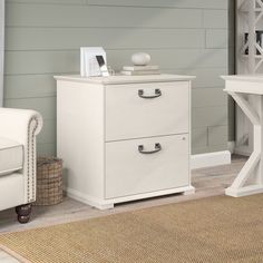 a living room with two white chairs and a table