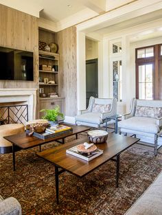 a living room filled with furniture and a fire place in the middle of a room