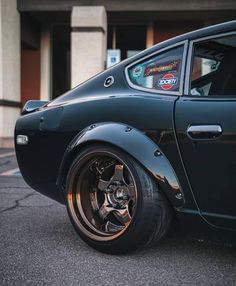 a black car parked in front of a building