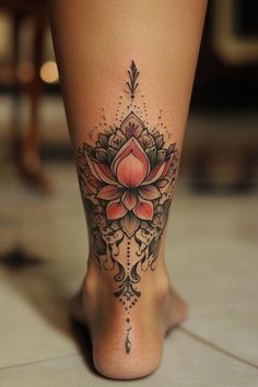 a woman's leg with a flower tattoo on it and an arrow in the center