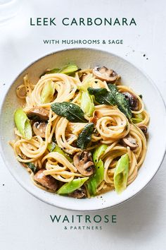 a white bowl filled with pasta and mushrooms