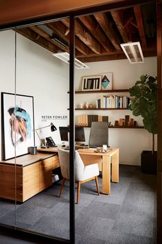 an office with a desk, chair and bookshelf