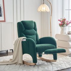 a green rocking chair with a blanket on it