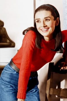 a woman sitting at a table with a cup and saucer