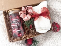 an open box with towels, candles and christmas decorations