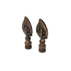 pair of antique brass candlesticks with dragon heads on each end, isolated against a white background