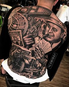 the back of a man's body covered in tattoos