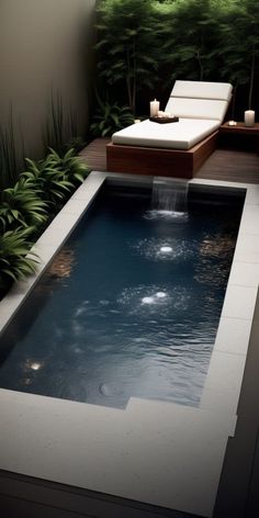 a small pool in the middle of a patio with lounge chairs and plants around it