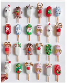 an assortment of christmas themed lollipops on sticks