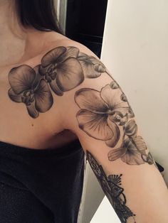 a woman's arm with flowers on it