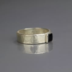 This beautiful 6mm onyx gemstone bezel set in sterling silver mixes a simple design with a masculine look. The band is made of sterling silver that I have given a shiny, hammered finish. The natural onyx is bold. Wear it as a pinky ring or a wedding band. Gorgeous on it's own or stacked with other rings! Materials: Stone: onyx Metal: silver Measurements: Gemstone size: 6mm Band: 6mm Since I use natural gemstones, each jewel is unique and therefore there are subtle differences in color and form. Masc Rings, Masc Jewelry, Ugly Engagement Rings, Silver Wedding Rings Men, Masculine Rings, Onyx Wedding Band, Hammered Ring Silver, Rings Materials, Hammered Wedding Ring