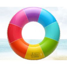 an inflatable ring sitting on top of a sandy beach next to the ocean