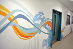 a hallway painted with colorful swirls and waves