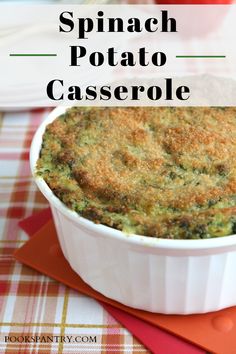 spinach potato casserole in a white dish on a red and yellow place mat