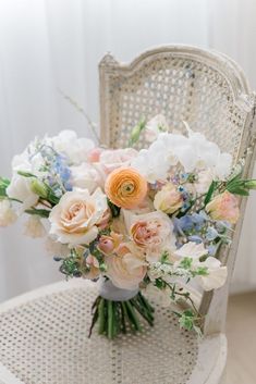 a bouquet of flowers sitting on top of a white chair