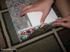 a person is opening a box on the floor