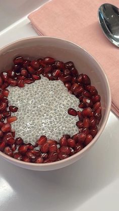 a bowl filled with red beans on top of a table