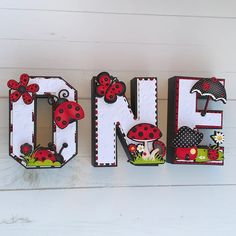 the letters are made out of wood and have ladybugs on them