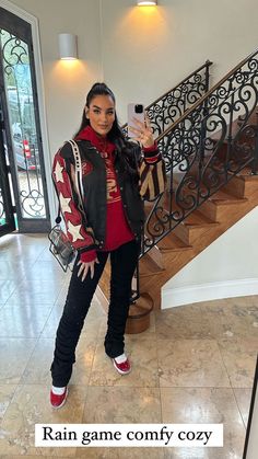 a woman taking a selfie while standing in front of stairs