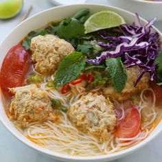 two bowls filled with meatballs and veggies