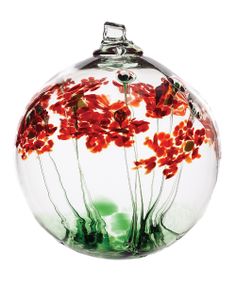 a glass vase with red flowers in it