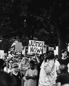 black and white photograph of people holding signs