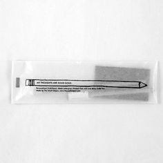 an eraser with a pencil in it on a white surface