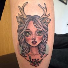 a girl with deer antlers on her head is shown in this tattoo art design