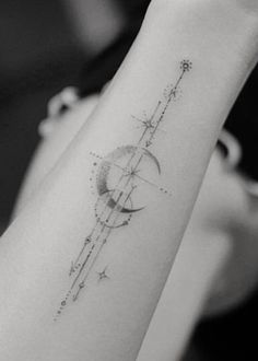 a woman's arm with a star and moon tattoo on the left side of her arm