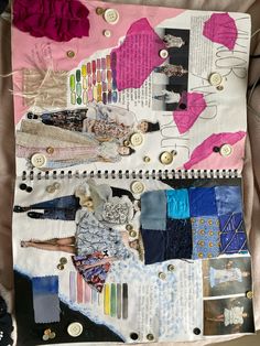 an open notebook with buttons and other items on it, including clothes pins and fabric