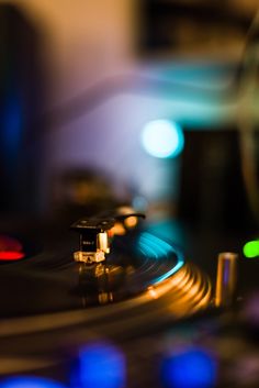 a turntable that is sitting in front of some blurry lights on the table